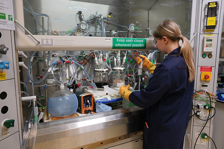 Smiling colleague by machinery