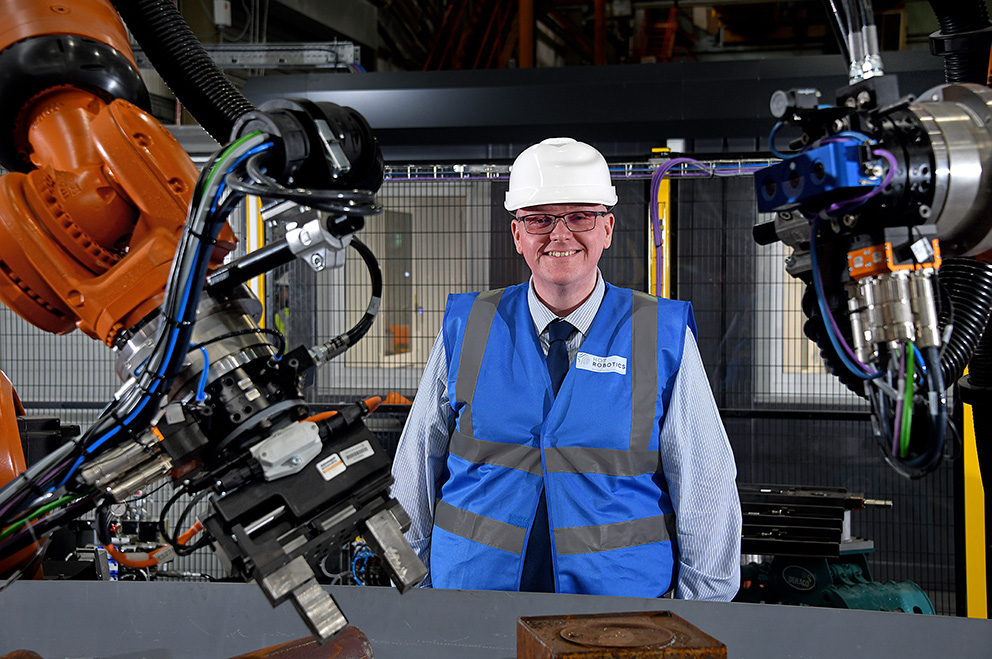 Smiling colleague with machinery