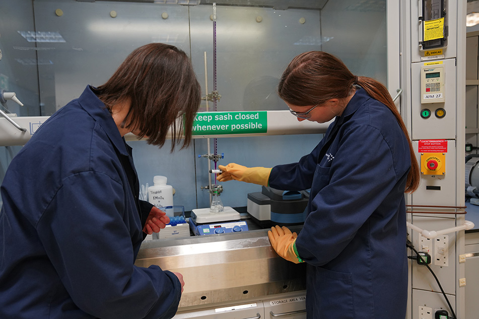 Female colleages run a test