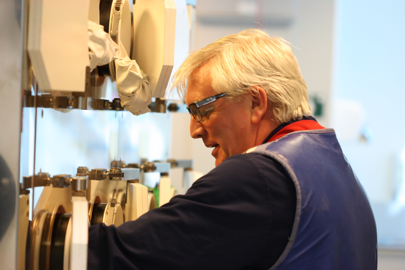 Colleages with his arm in a machine